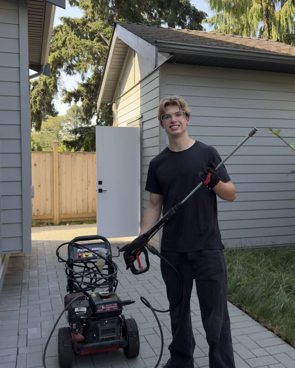 Nolan from West Wave Wash standing with exterior-cleaning equipment