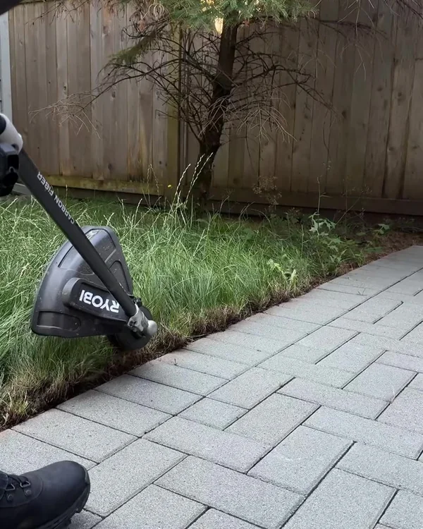 Edge cleanup beside an interlocking paver walkway